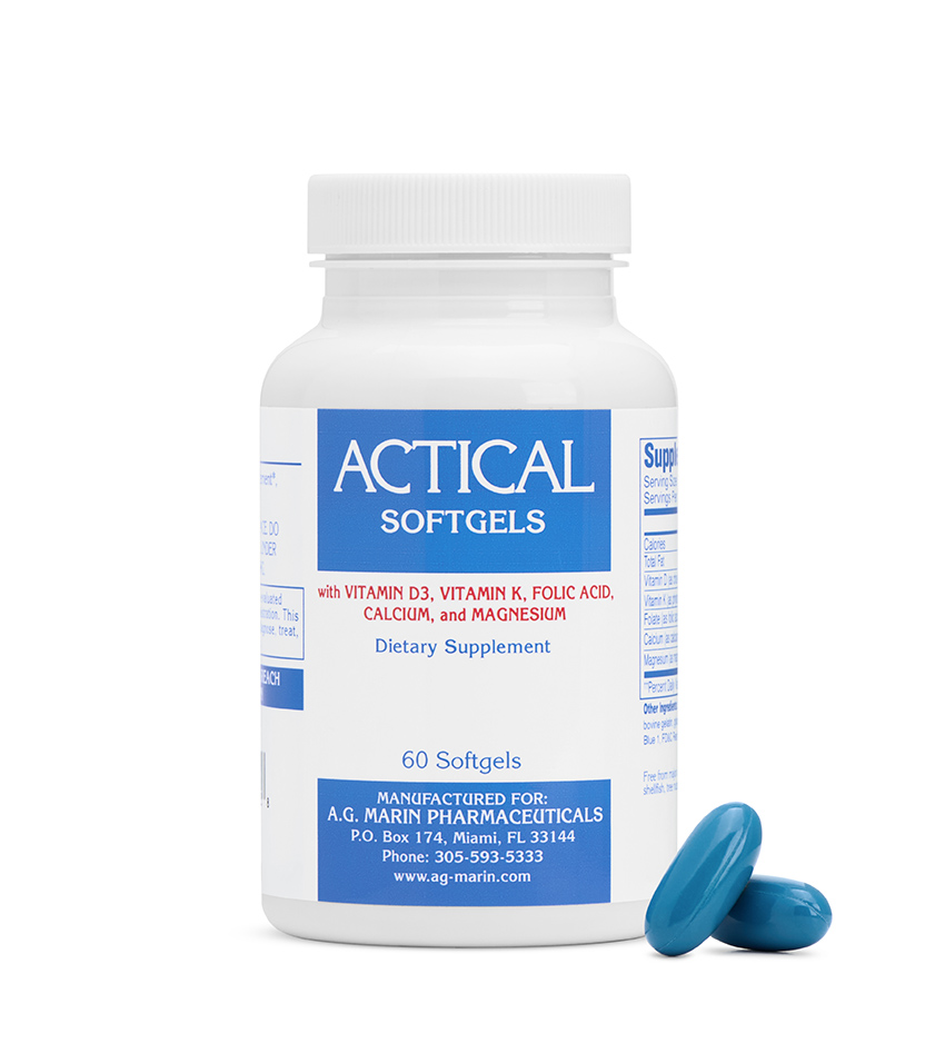 White background product photography of a blue-labelled softgel supplement bottle with two teal capsules beside it