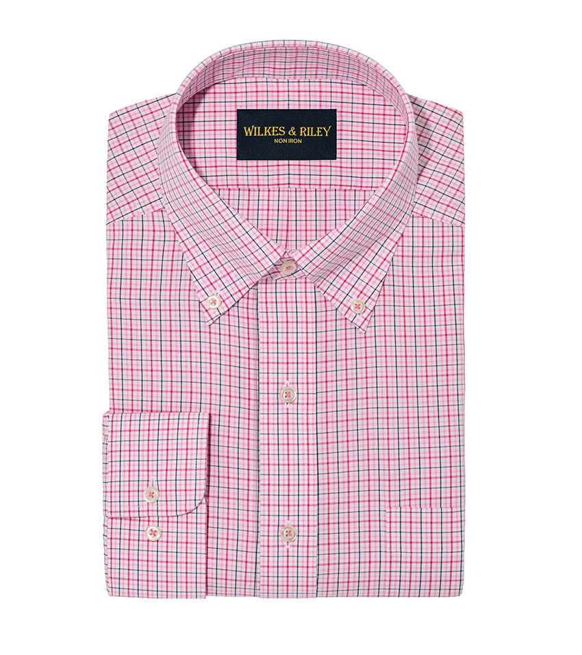 White background product photography of a pink check dress shirt folded with collar band and placket visible