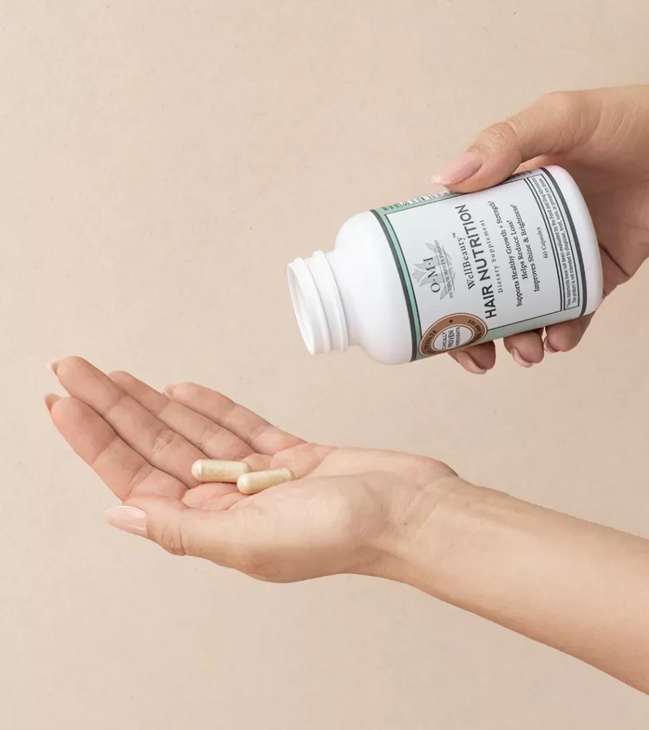 Lifestyle image of a supplement capsule being poured from a bottle into an open palm