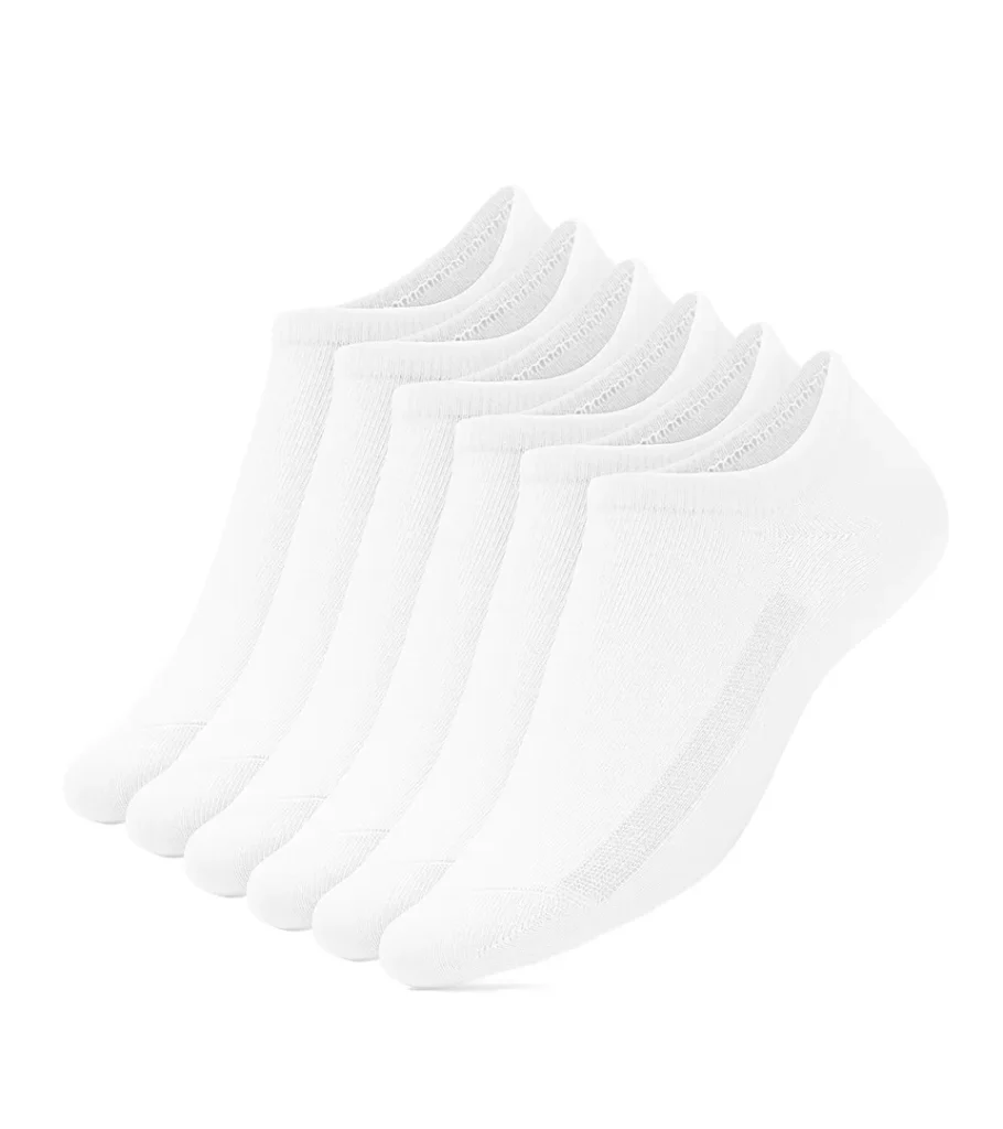 Product photography of a stack of white low-cut ankle socks fanned on a white background