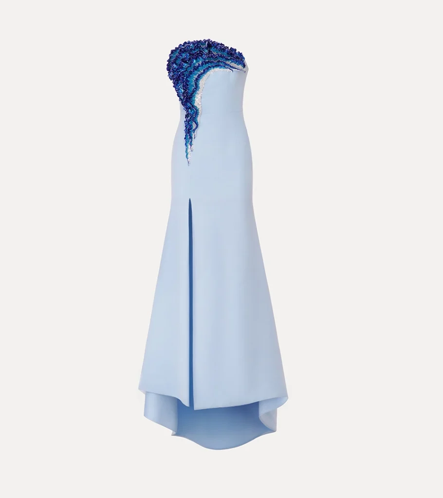 Ghost mannequin product photography of a light blue one-shoulder gown with textured ruffle trim, emphasizing the dress silhouette and premium fashion details.