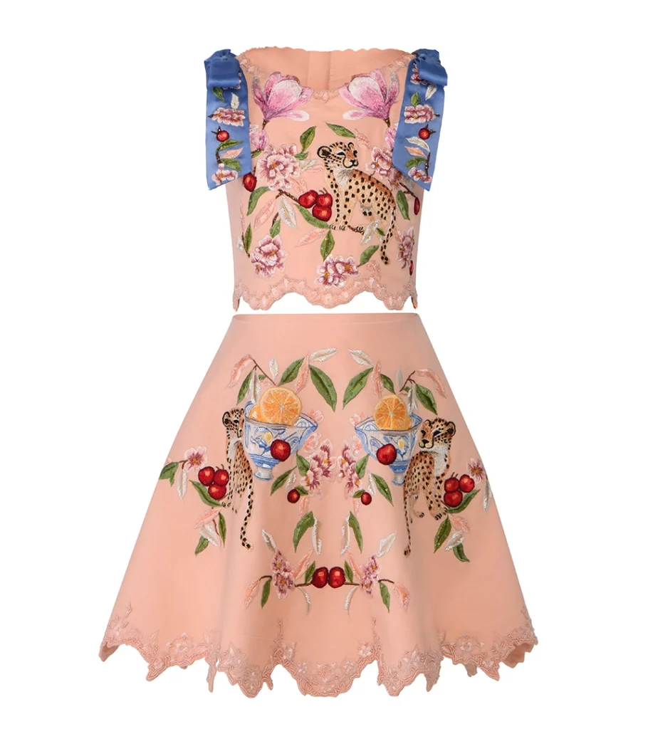 Professional ghost mannequin photography of an embroidered floral crop top and matching skirt set, highlighting intricate garment details and premium fashion craftsmanship for e-commerce.