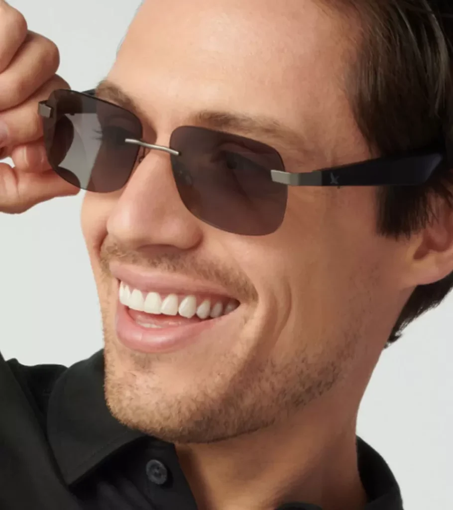 On-model photography of rimless gradient sunglasses worn by a smiling model, close-up portrait