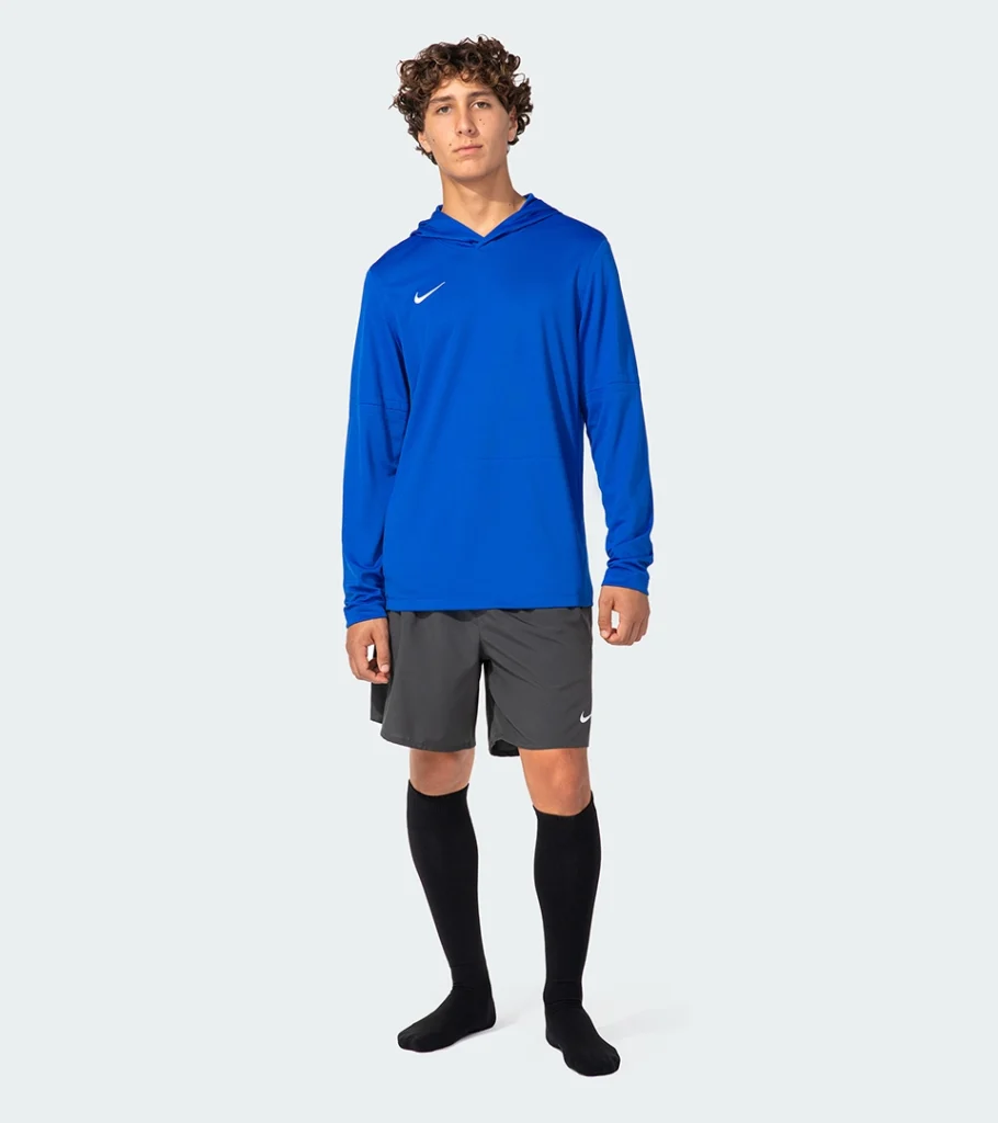 On-model photography of a blue hooded athletic top with grey shorts and knee-high socks
