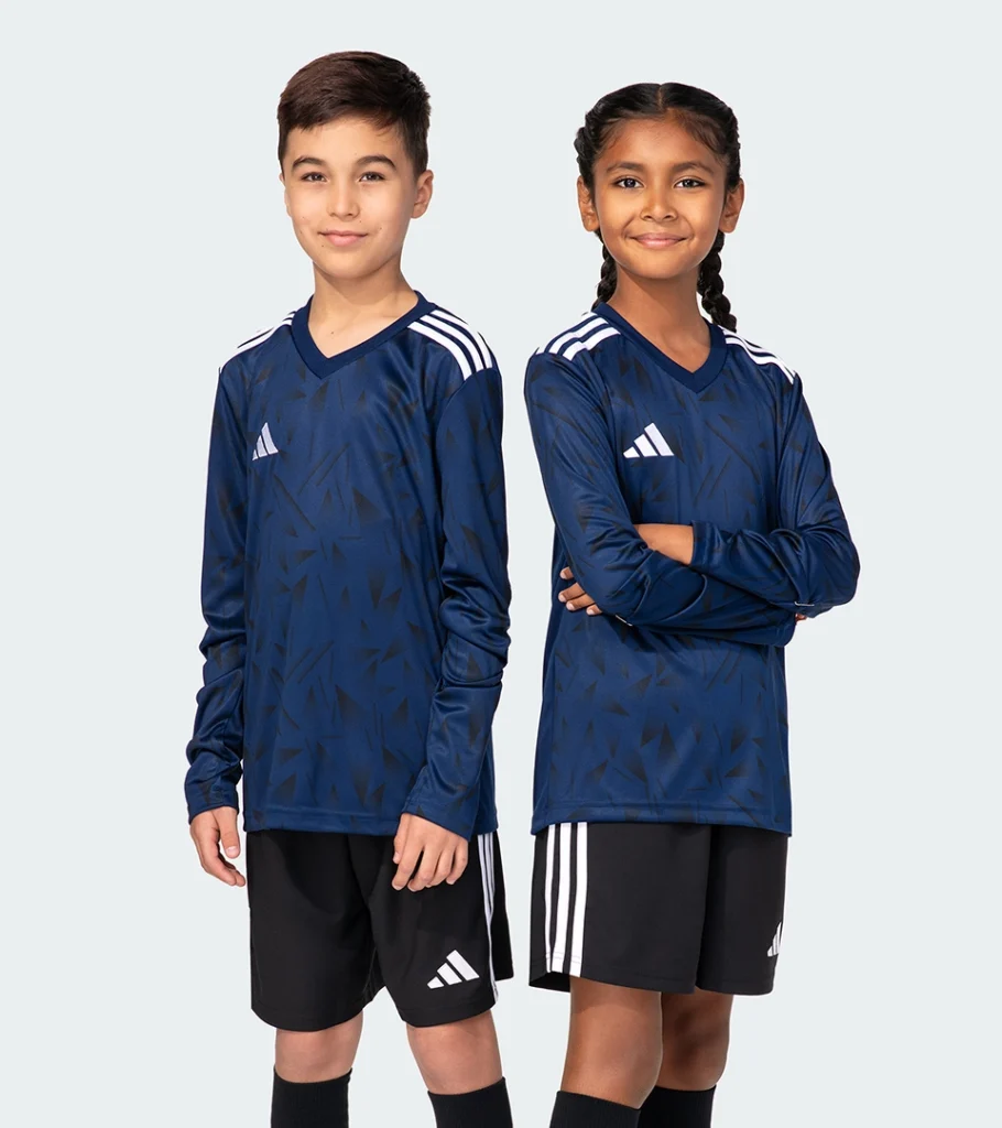 On-model photography of two kids' navy athletic jerseys with shorts, front view