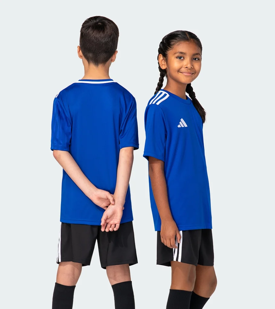 On-model photography of kids' blue soccer jerseys shown from back and side angles