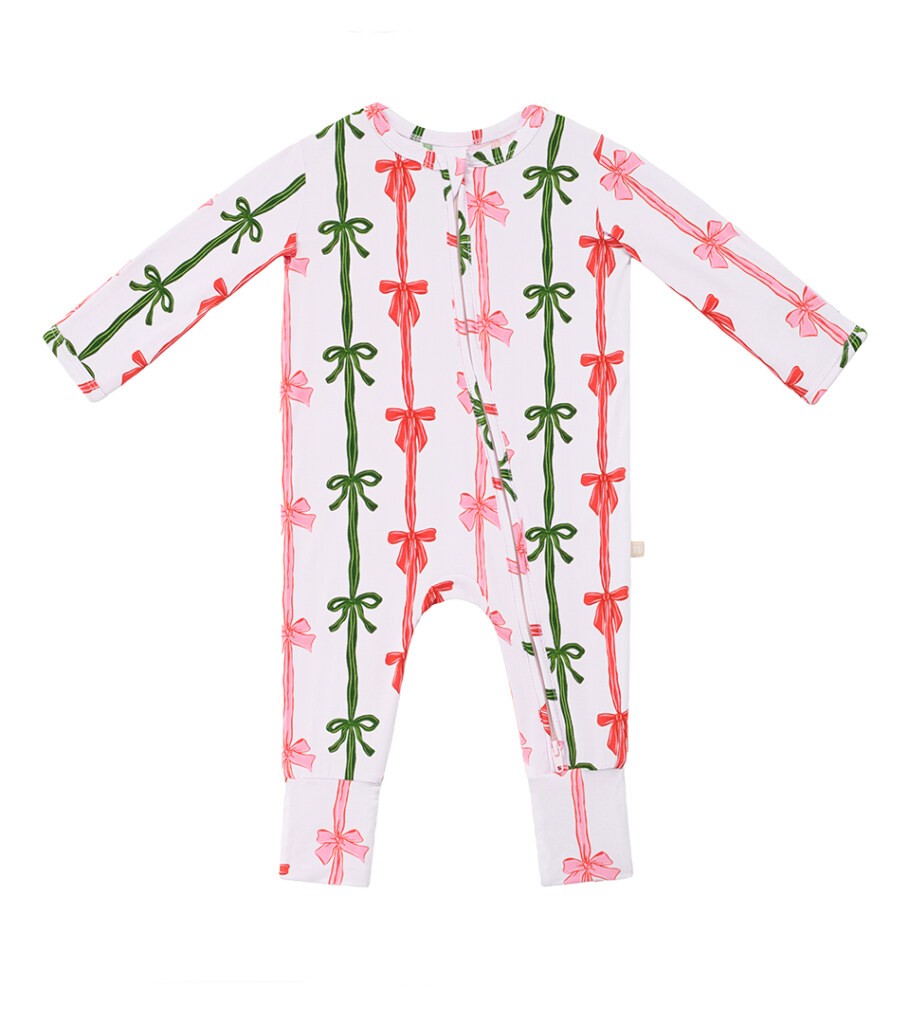 Flat lay photography of a white baby romper with pink and red bow stripe print