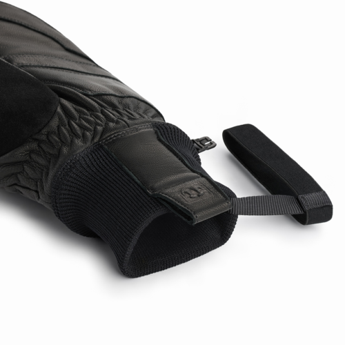 Detail product photography showcasing the leather cuff, elastic wrist, and premium craftsmanship of insulated black ski gloves.