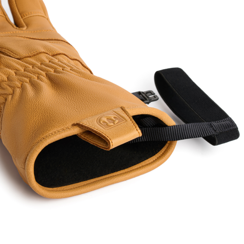 Close-up product photography highlighting the premium leather cuff, stitching, and wrist strap details of insulated ski gloves.