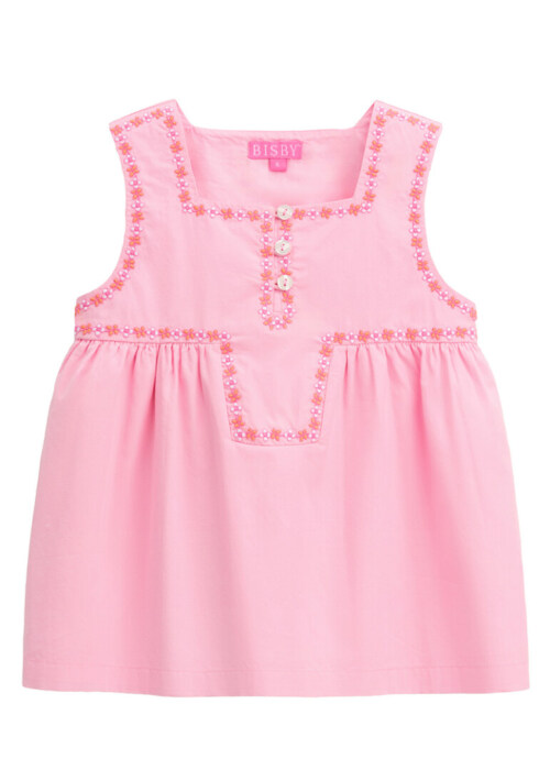 Flat lay photography of a pink sleeveless girls' dress with floral embroidered trim and button placket