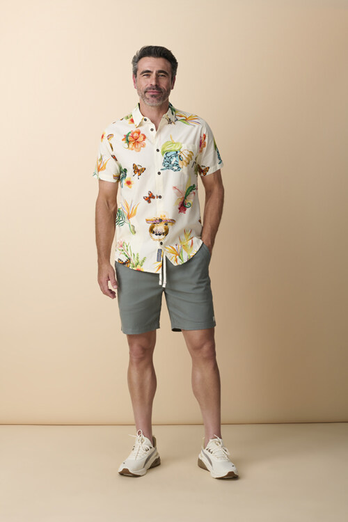 Male model wearing tropical print shirt and aqua shorts
