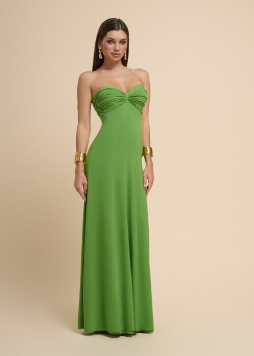 On-model photography of a green strapless maxi dress in a close three-quarter crop with gold statement earrings and cuff