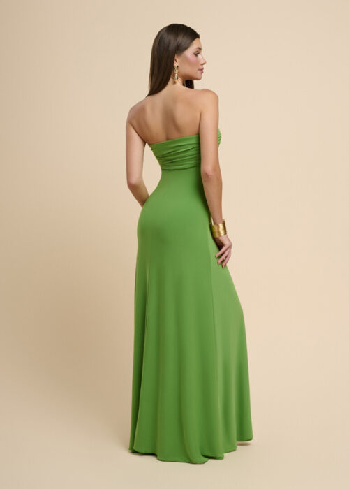 On-model photography of a green strapless maxi dress viewed from behind showing the ruched back bodice and flowing skirt