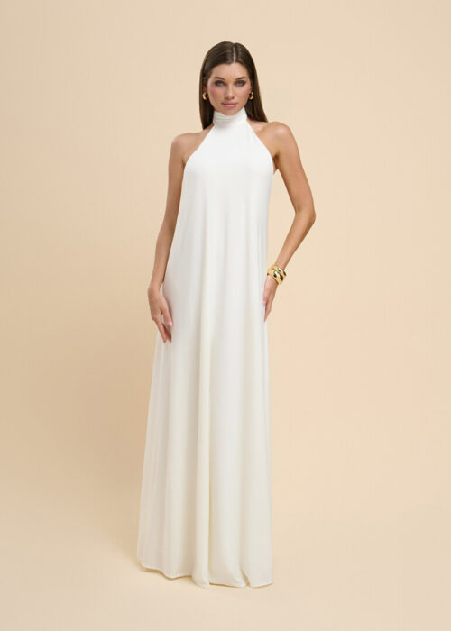 On-model photography of an ivory high-neck halter maxi dress with a floor-length A-line skirt