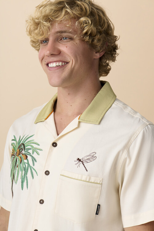 Portrait of male model wearing embroidered camp shirt