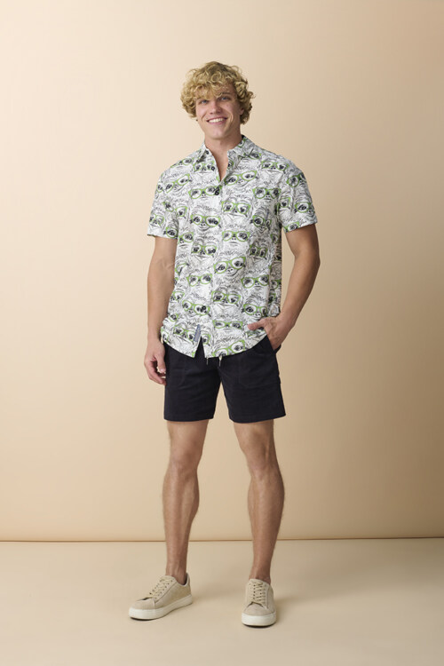 Profile portrait of male model wearing green tropical print shirt