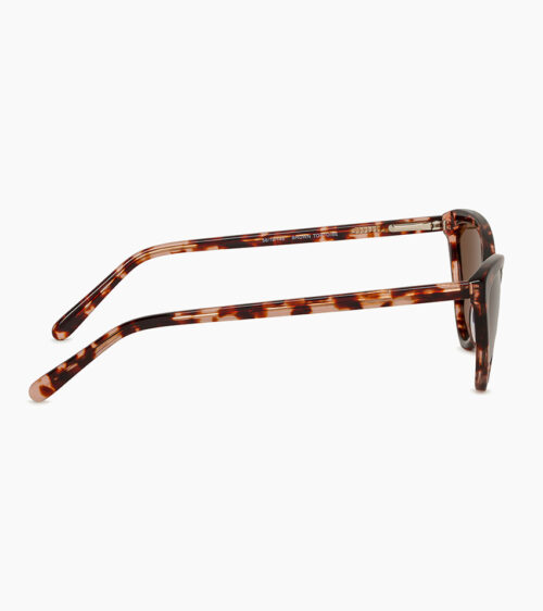 Sunglasses product photography of pink tortoiseshell cat-eye sunglasses in side profile showing the temple arms and hinge