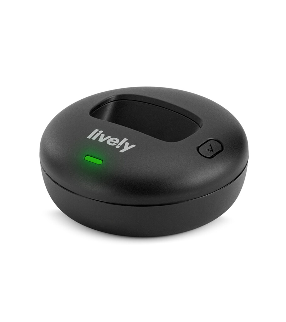 Product photography of a round black charging dock, three-quarter view