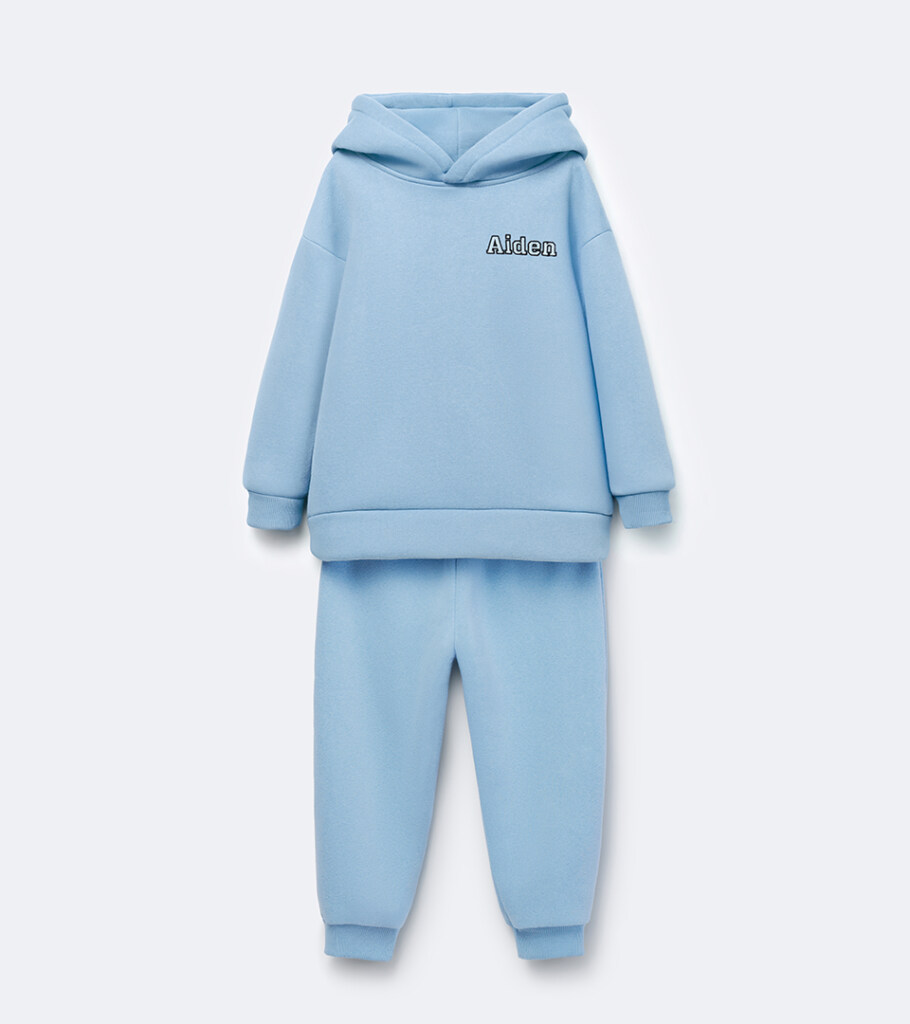 Flat lay photography of a light blue children's hoodie and jogger set photographed for e-commerce apparel photography.