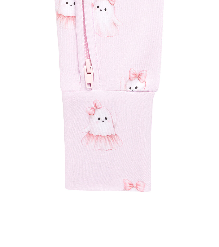 Macro detail photography of a pink baby garment zipper with bow-print fabric