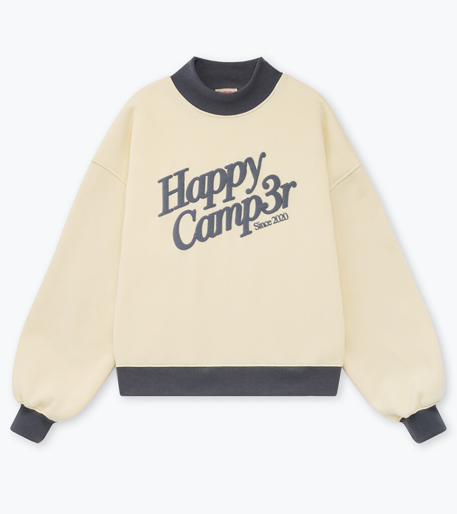 Flat lay photography of a cream graphic sweatshirt with charcoal contrast trim