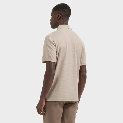 Back view of model in beige polo shirt showing collar and shoulder seams