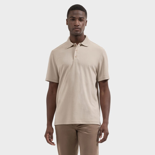 Model wearing beige short-sleeve polo shirt with tan trousers, front view