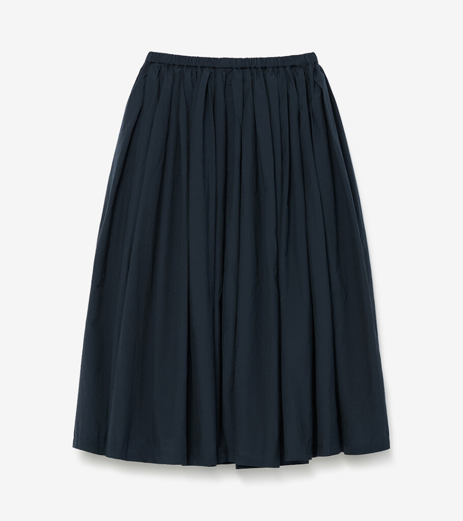 Flat lay photography of a navy gathered midi skirt, top-down view