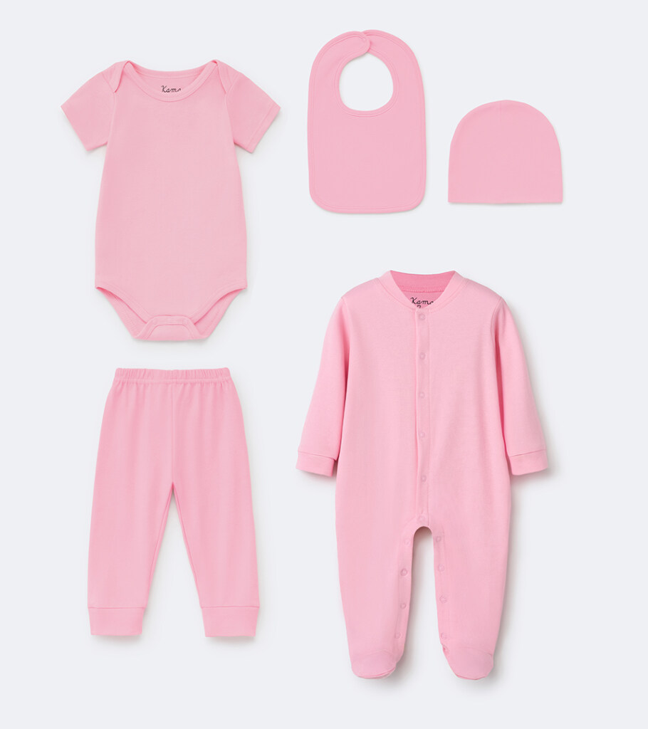Group flat lay photography of a pink baby layette set arranged top-down