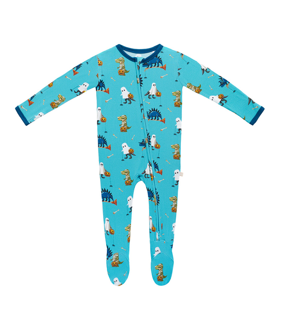 Flat lay photography of a turquoise zip-front baby sleeper with Halloween print