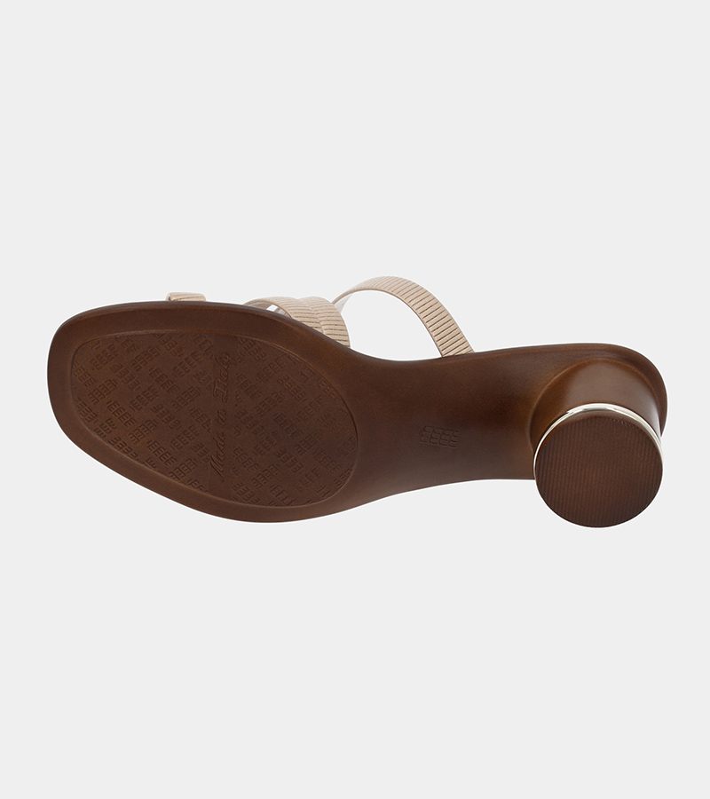 Automated product photography of the brown outsole and heel of a tan leather slide sandal, underside view