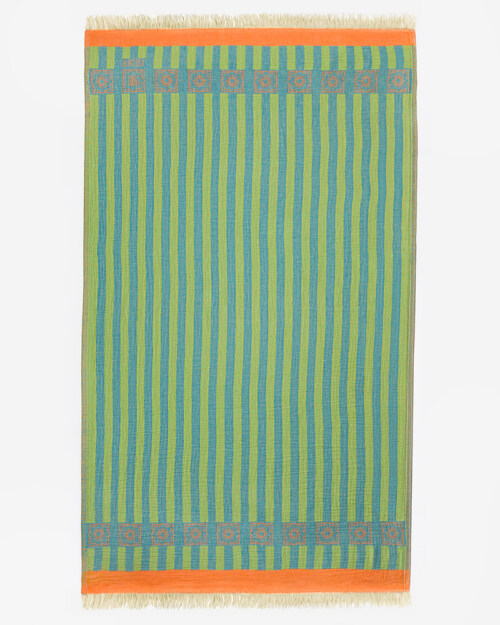 Flat lay photography of a green and blue striped towel with an orange border and fringed ends, shown full length
