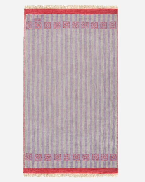 Flat lay photography of a lavender and grey striped towel with a red border band, shown full length