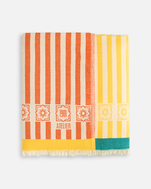 Product photography of a coral striped towel and a yellow striped towel folded together as a pair