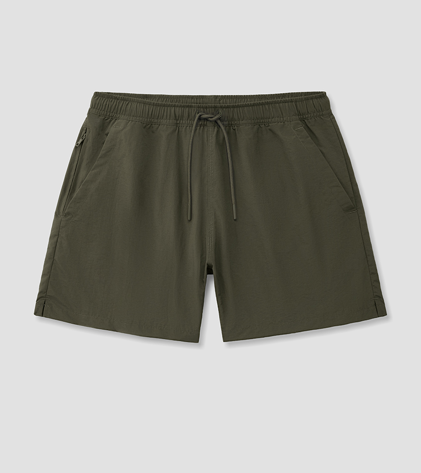 Flat lay photography of olive green swim shorts with a matching drawstring waistband, laid flat and pressed