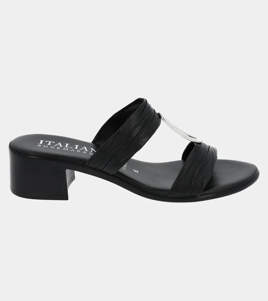 Automated product photography of a black slide sandal with a clear vinyl strap and a low block heel, angled side view