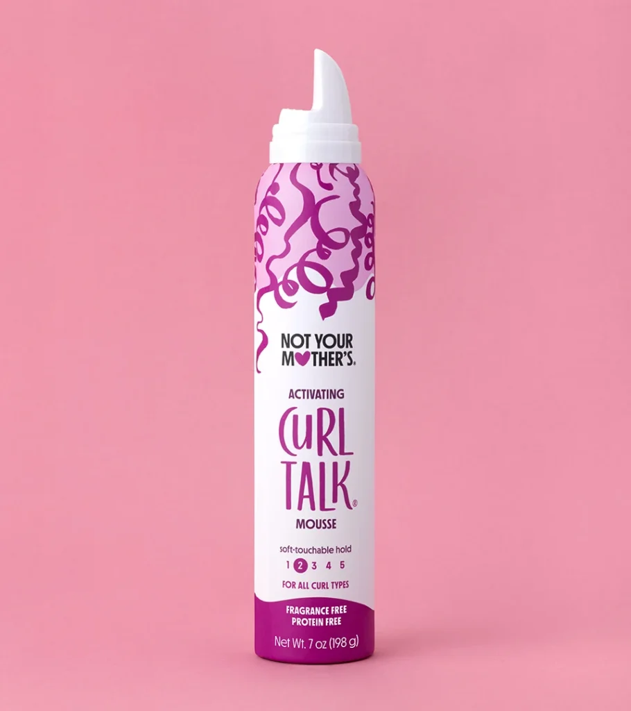 Editorial product photography of a white and magenta mousse can on a pink background
