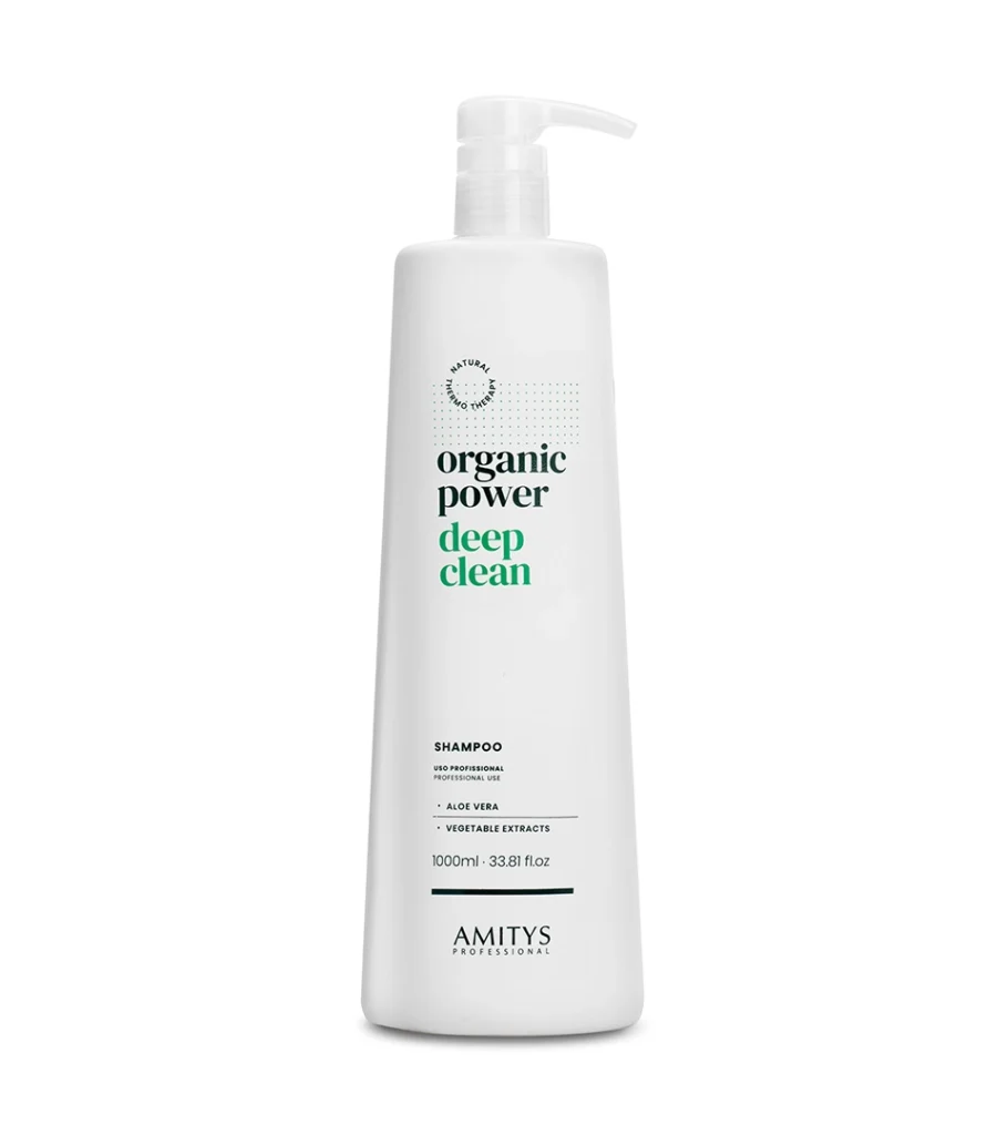Product photography of a white pump bottle with green lettering for a clarifying hair cleanser, on white