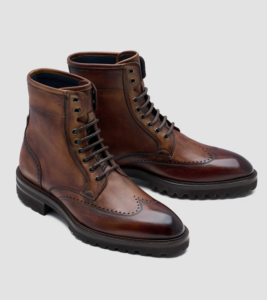 Shoe product photography of a burnished brown leather lace-up boot at a front three-quarter angle