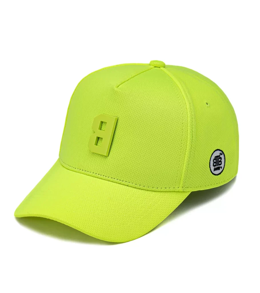 Product photography of a neon yellow baseball cap with tonal logo detail, side view