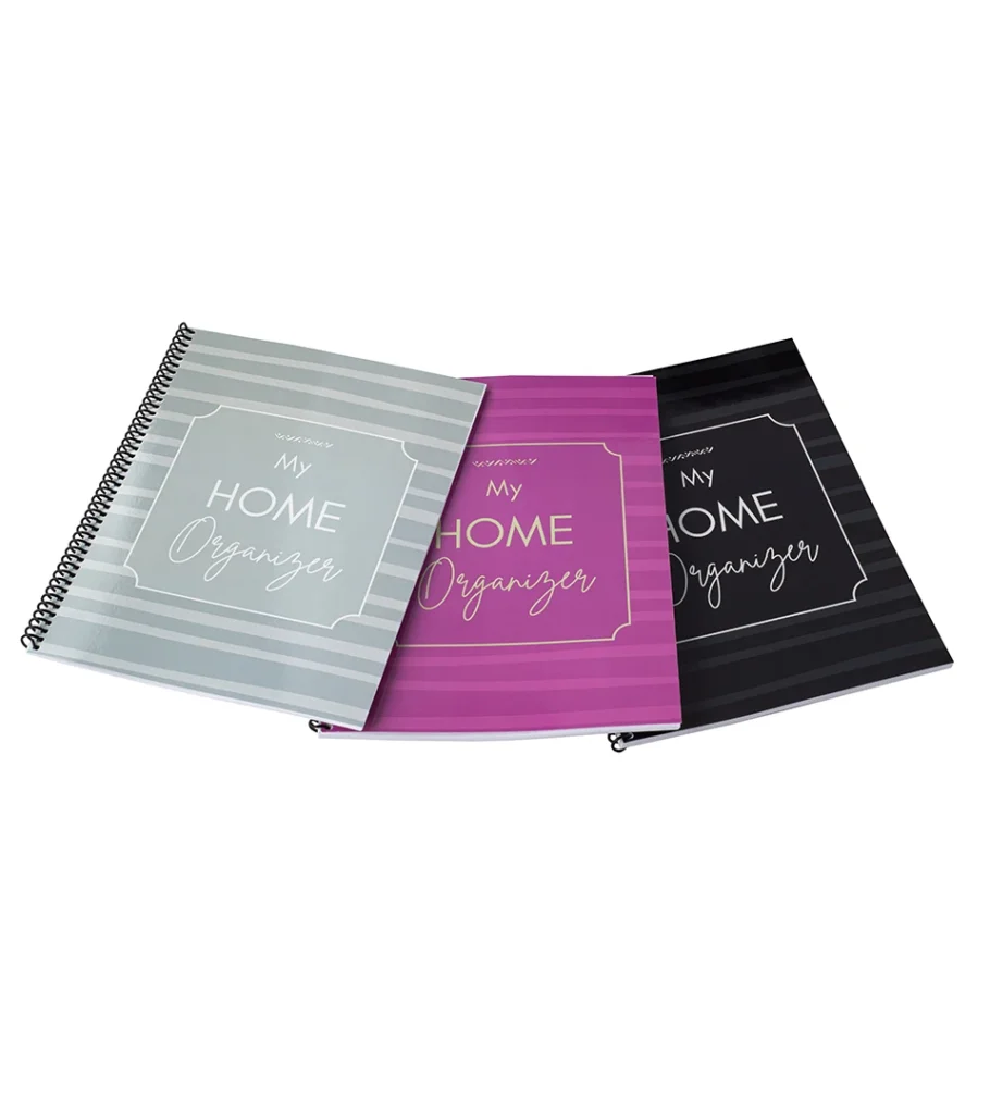 Product photography of three spiral-bound organizer notebooks in sage, magenta and black, fanned as a set