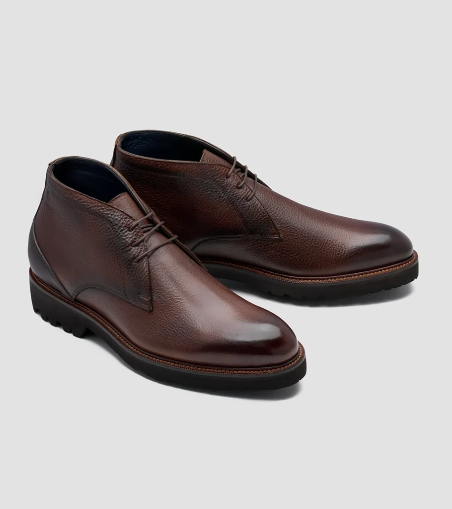 Shoe product photography of a burgundy leather lace-up boot at a front three-quarter angle