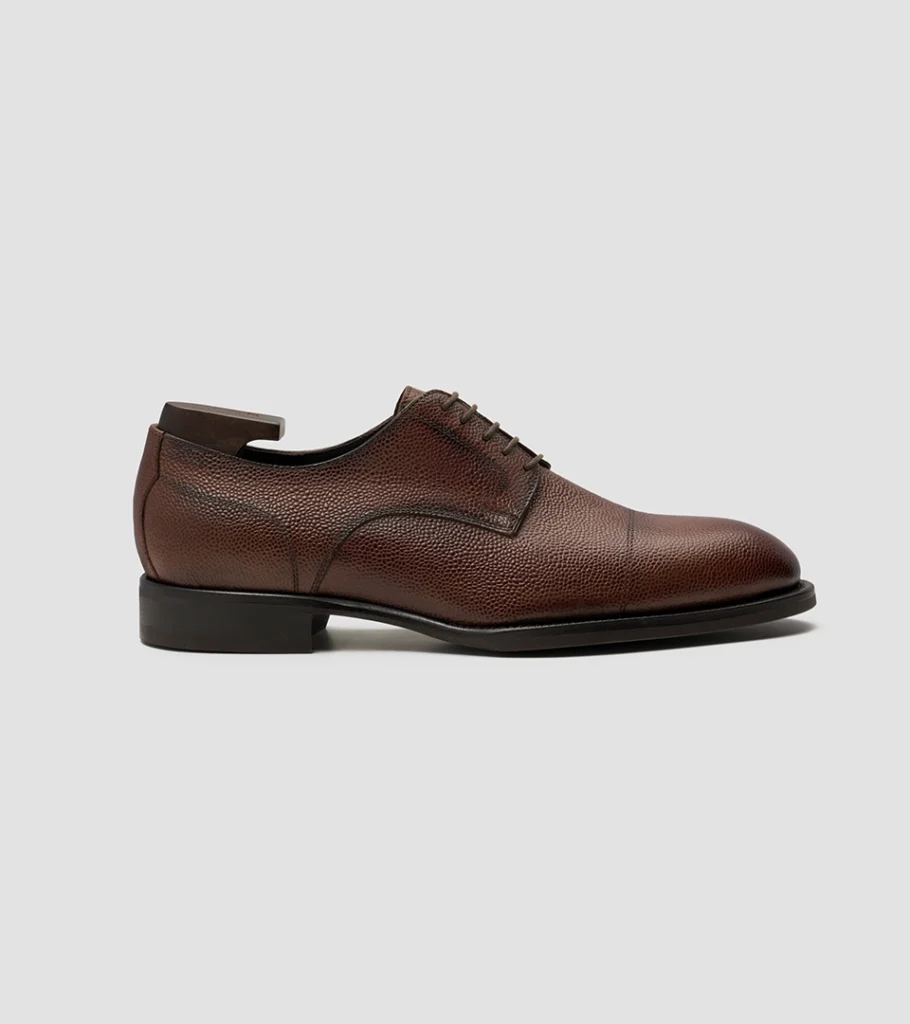Shoe product photography of a burgundy leather derby shoe angled to show the vamp and lacing