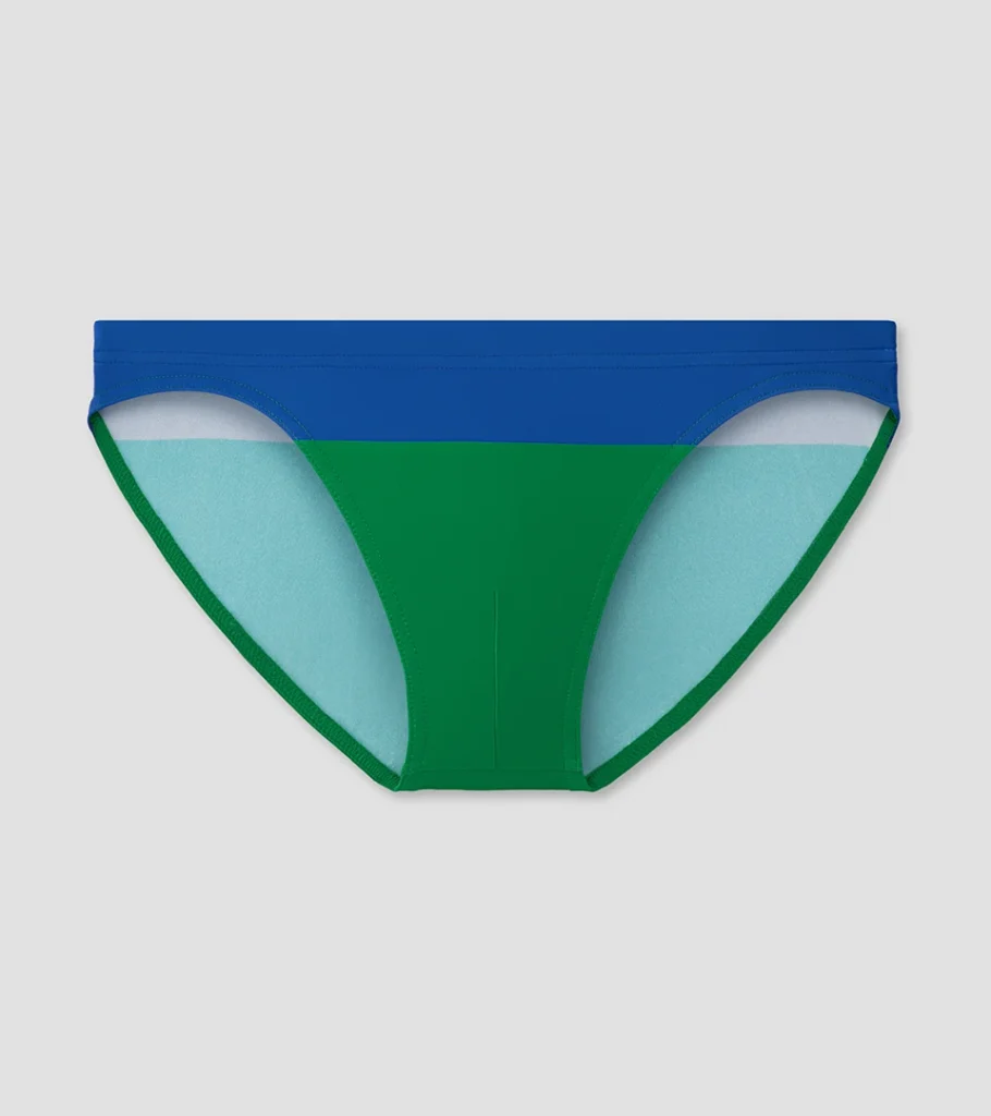 Professional swimwear product photography of blue and green men's swim briefs, showcasing color-block design, fabric texture, and clean e-commerce presentation.