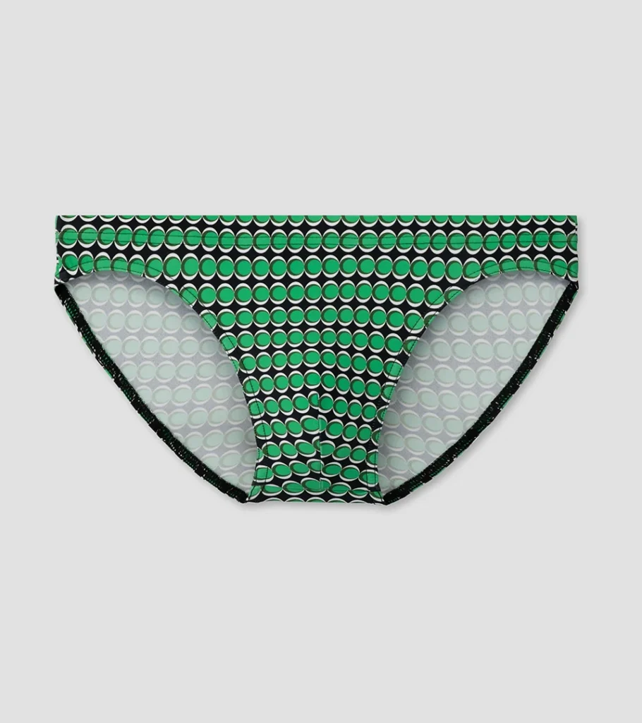 Swimwear product photography of green patterned men's swim briefs, highlighting the printed fabric, fit, and premium product details for men's swimwear e-commerce.