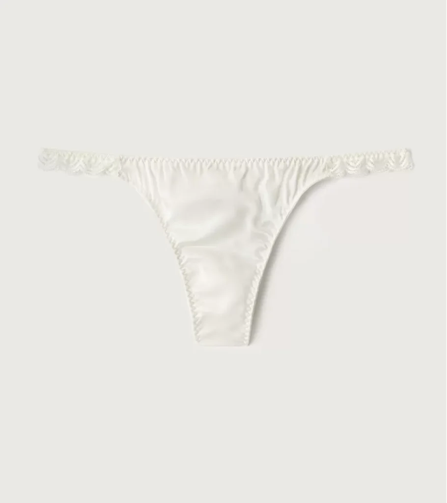 Underwear product photography of white women's thong panties, highlighting the fabric texture, fit, and premium lingerie details for e-commerce.