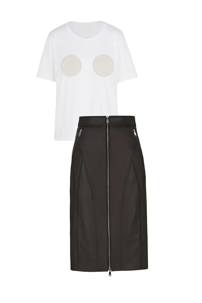 Ghost mannequin photography of a white T-shirt with circular spiral appliqués and a black leather zip-front pencil skirt on white