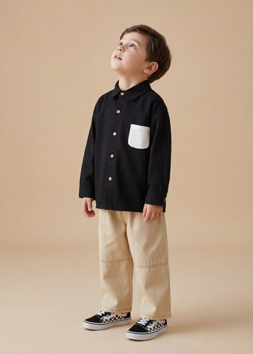 AI model photography of a black long-sleeve kids shirt with white chest pocket, worn with khaki pants, side pose