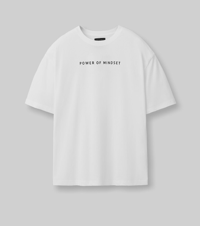flat lay ecommerce clothing photography of t-shirts and pants on neutral background