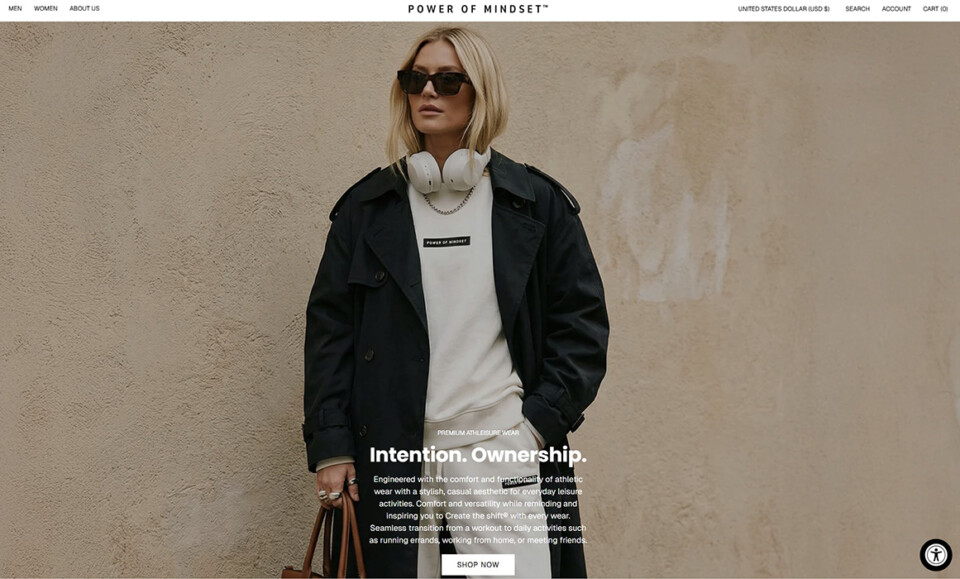 AI-generated models for fashion by Shootify. Power of Mindset homepage hero banner with model in a cream sweatshirt and black trench coat against a beige textured wall.